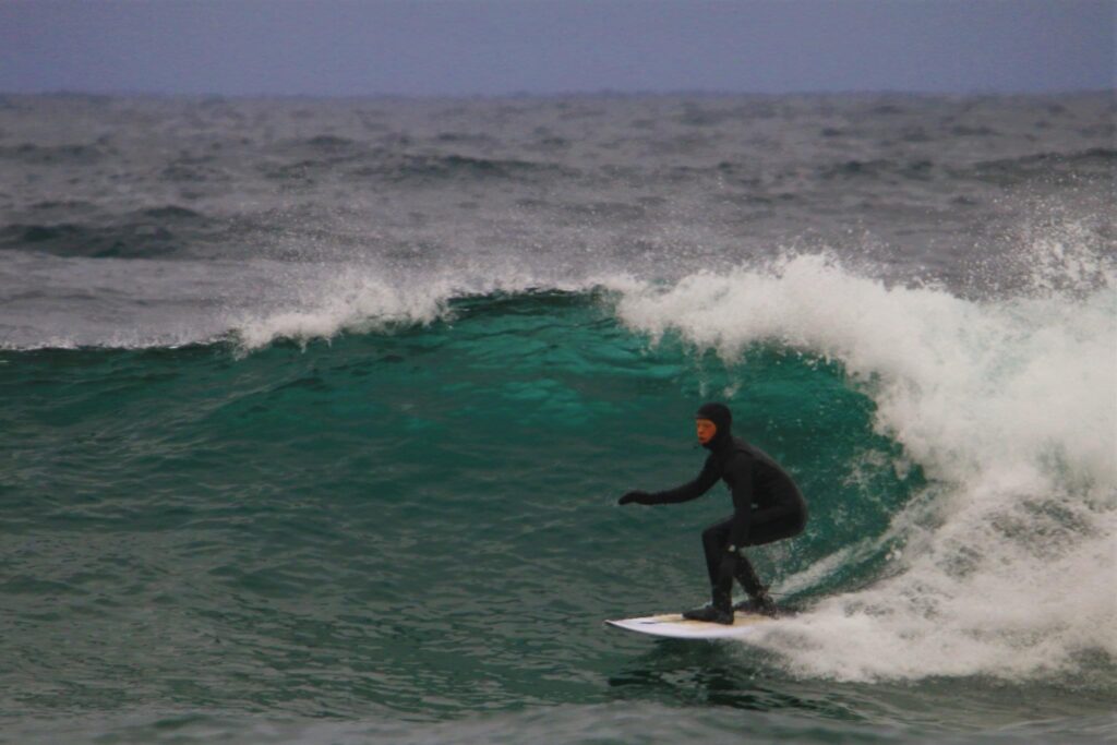 Kyler Stolp Surfing on the Waves of Lake Superior in January with a Sauna