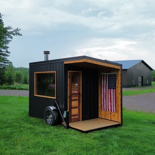 Mobile sauna trailer with full-height cedar door and picture window